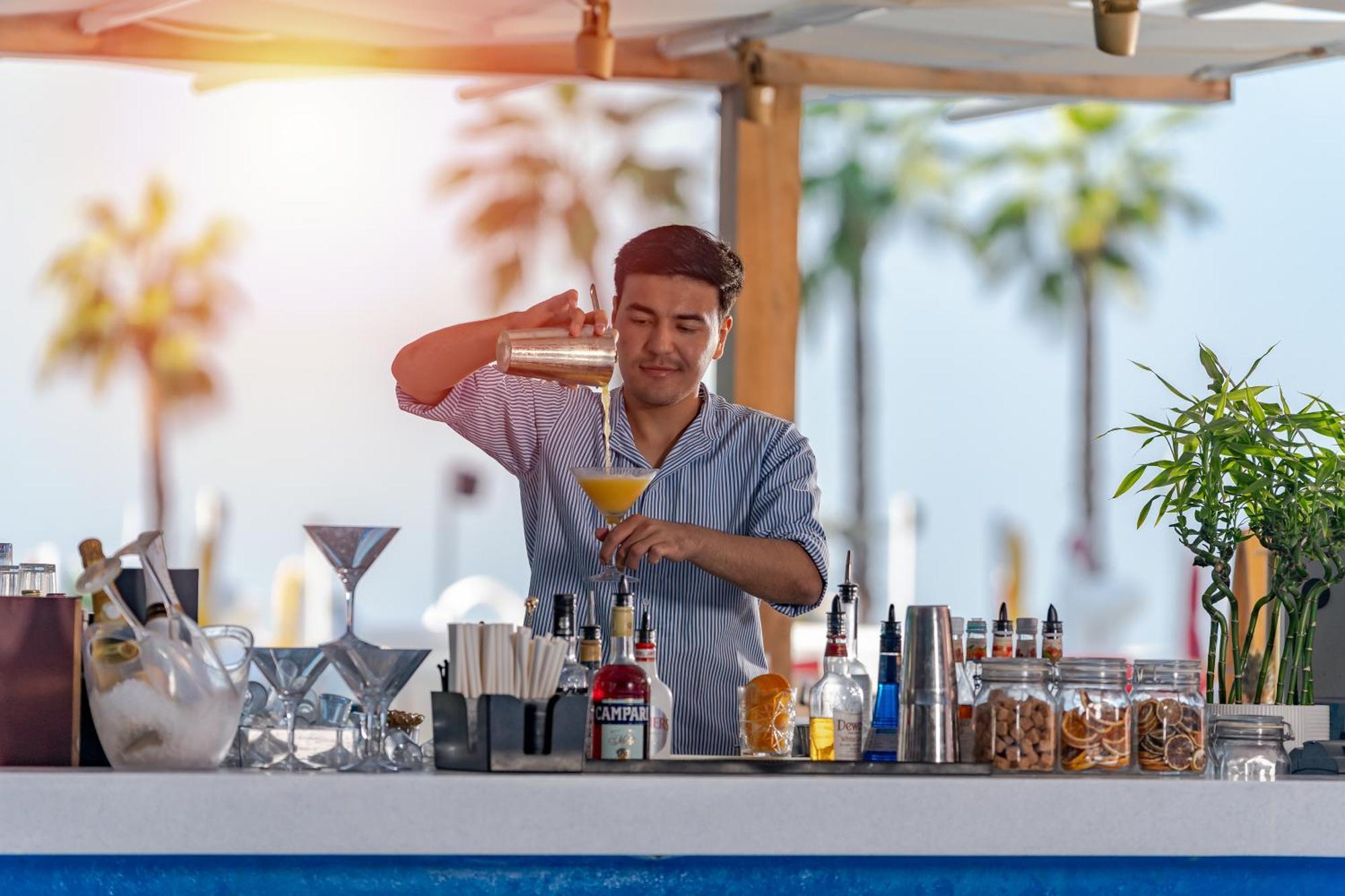 Voco Monaco Dubai By Ihg, Adults Only, World Islands Hotel Exterior photo A bartender at work